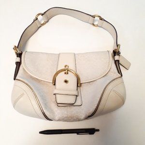 logo white and gold coach baguette bag